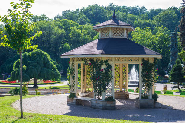 istock Gazebo surrounded with lush park trees 2158082764