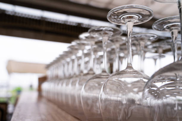 istock Wine glasses lined up in a row ,Background blurring of light 2158082849