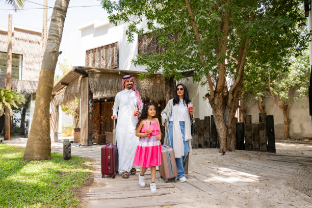 istock Saudi family walking through resort grounds 2158083892
