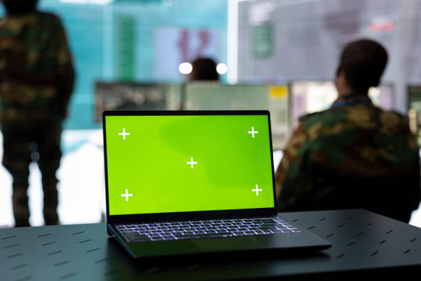 istock Laptop showing isolated green screen in military power base 2158084380