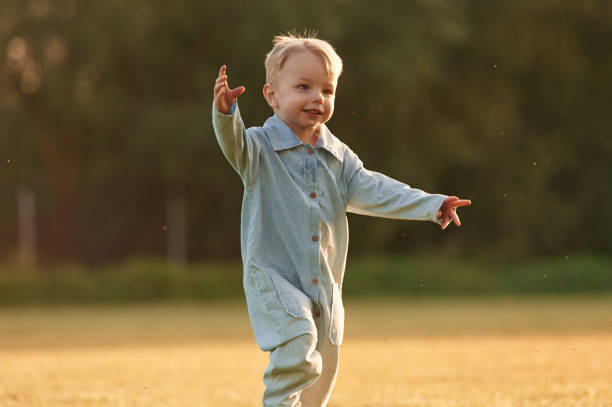 istock Having fun, running. Little boy is on the summer field 2158089480