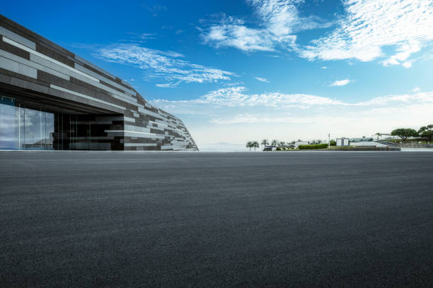 Empty asphalt square road and modern city skyline background. Clean car road background
