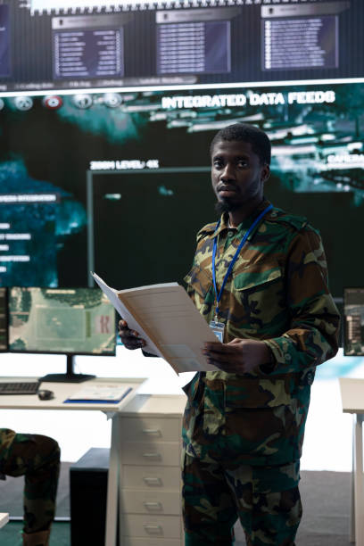 istock Navy operations specialist reading new mission case files in command center 2158090493