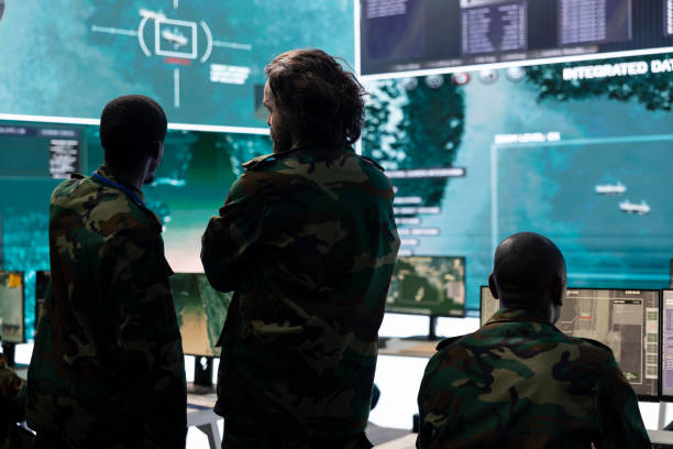 istock Military personnel discussing about enemy vessel trajectory in control room 2158090588