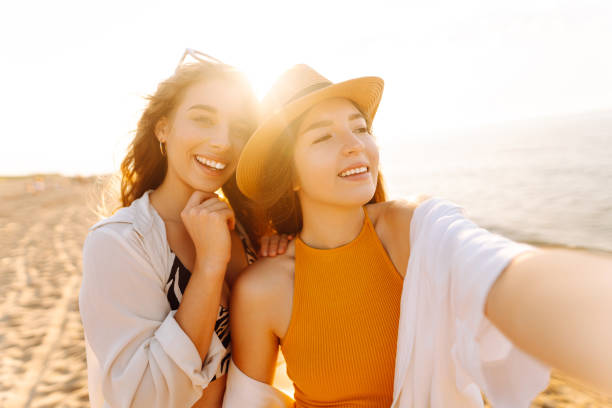 istock Cheerful women making selfie while having fun on the beach. 2158091006