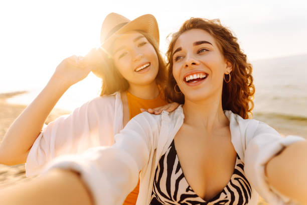 istock Cheerful women making selfie while having fun on the beach. 2158091017