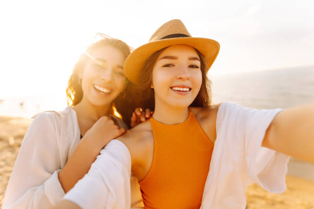 istock Cheerful women making selfie while having fun on the beach. 2158091048