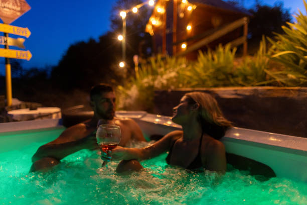 istock Couple in jakuzzi relaxing and drinking wine 2158091159