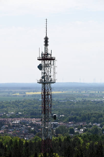 A 95 m high transmitter mast. Aerial view of mobile phone cell tower over forested rural area. A station transmitting radio and television waves.