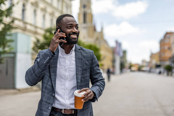 istock An elegantly dressed black businessman walks through the city 2158094991