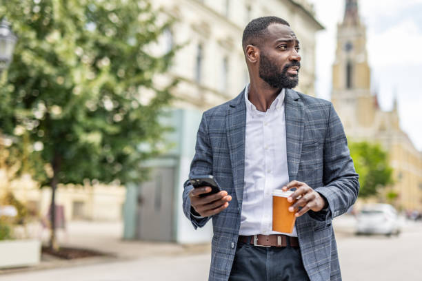 istock An elegantly dressed black businessman walks through the city 2158095007