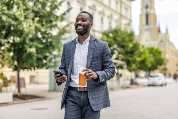 istock An elegantly dressed black businessman walks through the city 2158095008