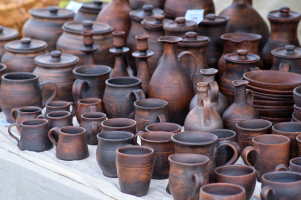 istock A table full of brown pottery, including cups, bowls, and vases 2158096364
