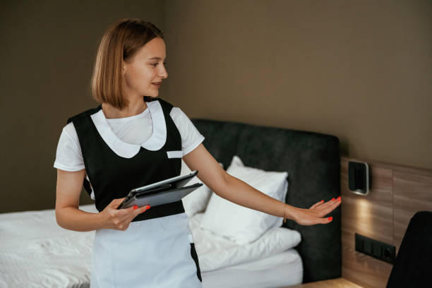 istock Digital tablet in hands. Young chambermaid is in hotel room 2158096908