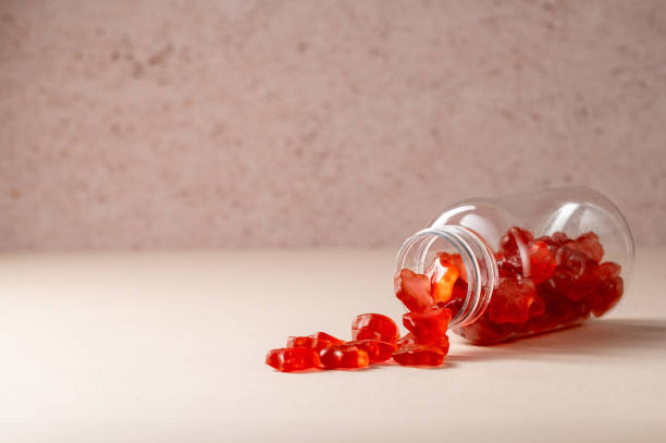 Fruit jelly gummy vitamins in a jar, food supplement.