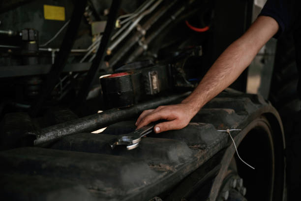istock Close up view. Mechanic's hand fixing machinery with wrench in workshop 2158098152