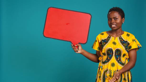 istock Smiling person showing a red isolated speech bubble in studio 2158098224