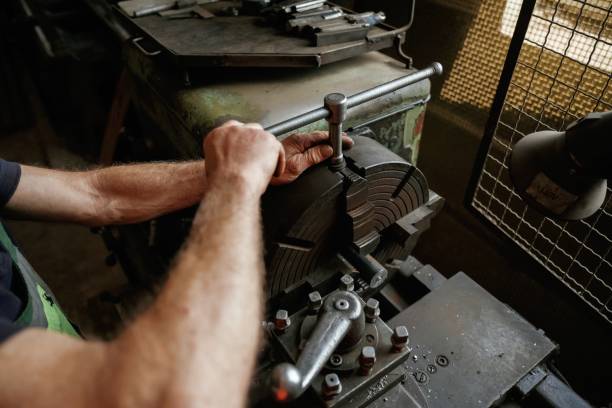 istock Focused view. Close-up of worker's hands operating industrial machinery in workshop 2158098262