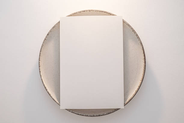 istock Blank White Paper Card Copy Space Mockup on Cream-Colored Plate 2158099649
