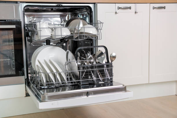 istock Time-saving technology. Open built-in dishwasher. Kitchen with integrated appliances. Clean plates and dishes in the dishwasher 2158100021