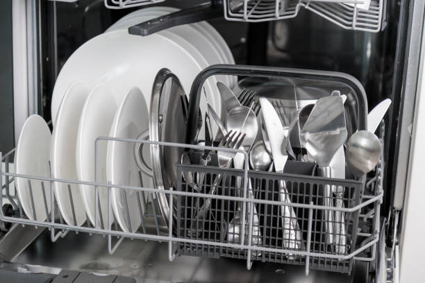 istock Time-saving technology. Open built-in dishwasher. Kitchen with integrated appliances. Clean plates and dishes in the dishwasher 2158100172