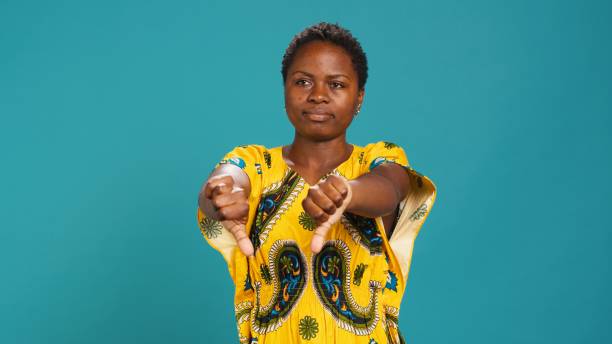 istock Dissatisfied person showing thumbs down symbol in studio 2158101179