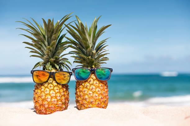 istock Two pineapples with trendy sunglasses in tropical paradise 2158101993