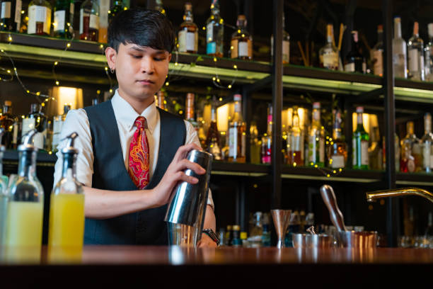 istock Professional bartender preparing alcoholic cocktail serving  to customers at bar. 2158102721