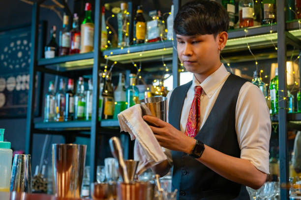 istock Professional bartender preparing alcoholic cocktail serving  to customers at bar. 2158102731