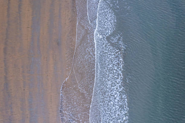istock Aerial view of beach at sea with waves 2158103123