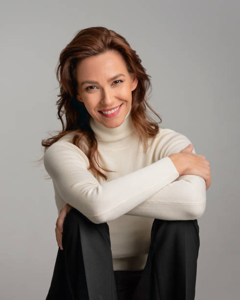 istock Attractive brunette haired woman sitting at isolated background 2158103564
