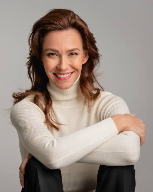 istock Attractive brunette haired woman sitting at isolated background 2158103569