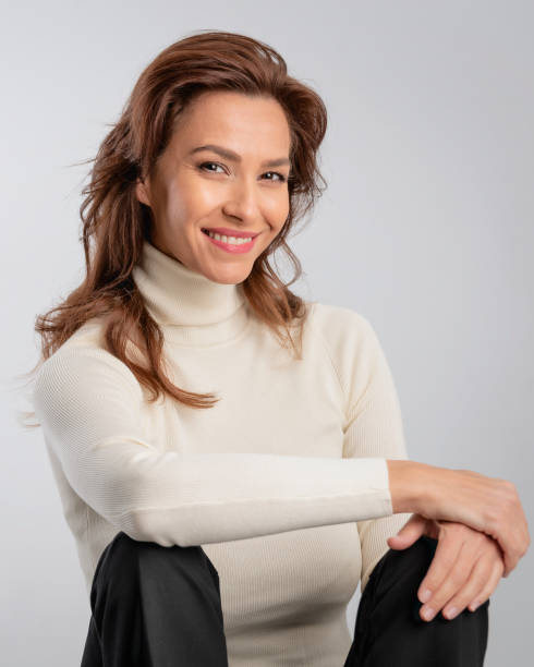 istock Attractive brunette haired woman sitting at isolated background 2158103570