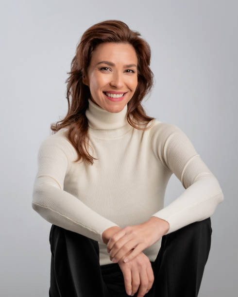 istock Attractive brunette haired woman sitting at isolated background 2158103572