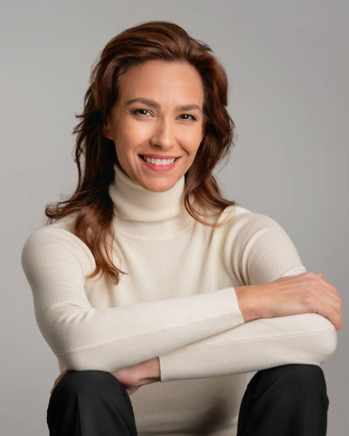 istock Attractive brunette haired woman sitting at isolated background 2158103579