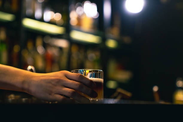 istock Professional bartender preparing alcoholic cocktail serving  to customers at bar. 2158104520