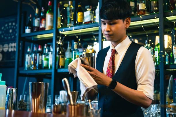 istock Professional bartender preparing alcoholic cocktail serving  to customers at bar. 2158104533