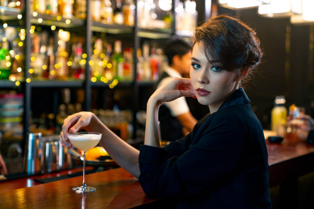 istock Caucasian woman drinking cocktail at luxury bar. 2158106068