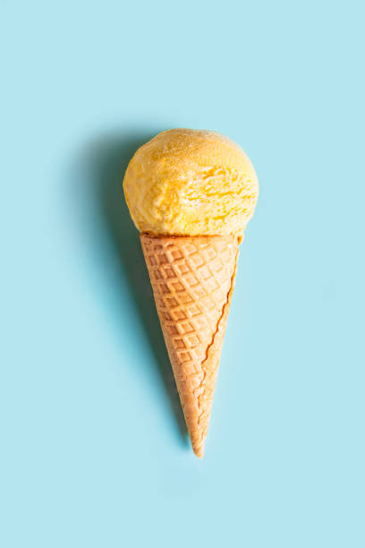 istock Yellow ice cream cone on blue background 2158108087