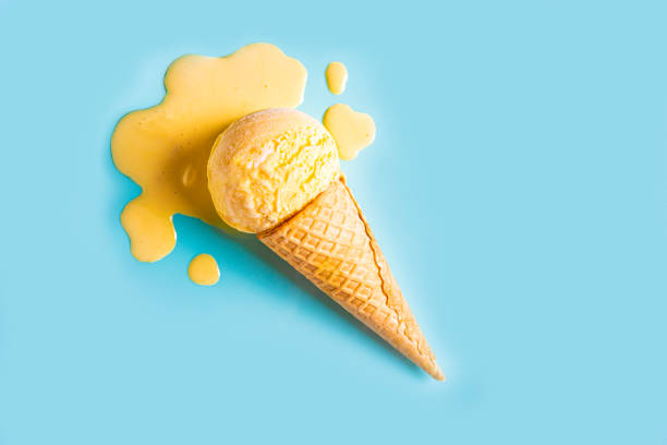 istock Yellow mango ice cream melting and spilling 2158108248