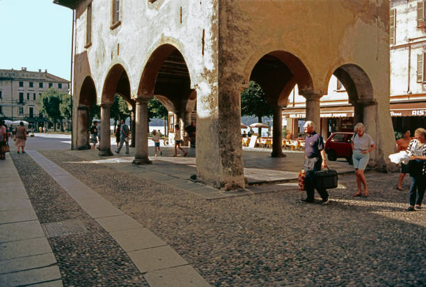 Orta San Giulio, Piedmont, Italy, 17 August 1992: in the center of the town, which overlooks the lake of the same name and is part of the circuit of the most beautiful villages in Italy, tourists near Piazza Motta where the boats moor.
