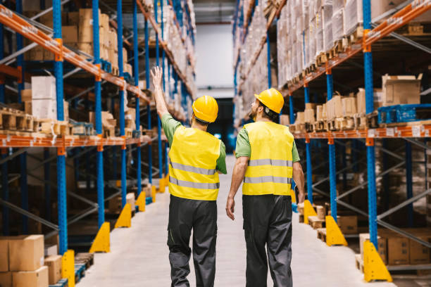istock A warehouse worker explaining to new warehouse man how to organize box in goods in facility. 2158110726