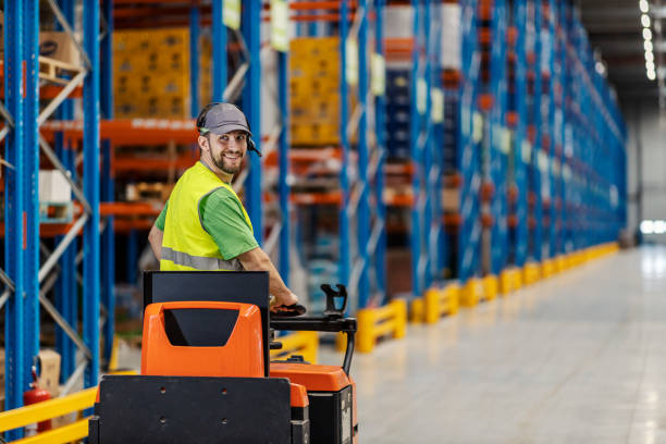 istock A warehouseman is driving forklift in facility. 2158110773