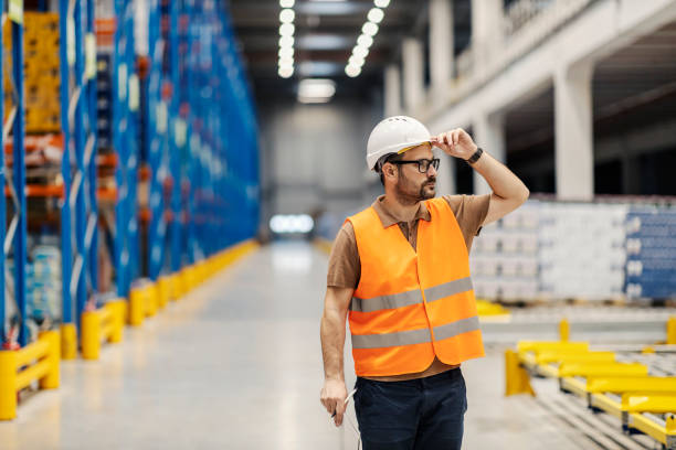 istock A delivery center supervisor is holding folder with files and inventorying in facility. 2158111339