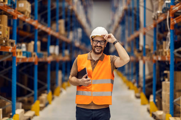 istock A distribution center supervisor holds tablet under armpit and greets visitors. 2158111351