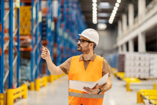 istock A delivery center manager is walking trough facility with folder and documentation in his hands. 2158111397