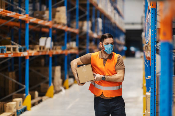 istock A delivery center worker is preparing box for shipment during pandemic. 2158111476
