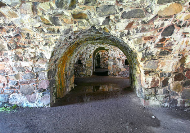 Rough brown wall with a rectangular metal-lined hole.