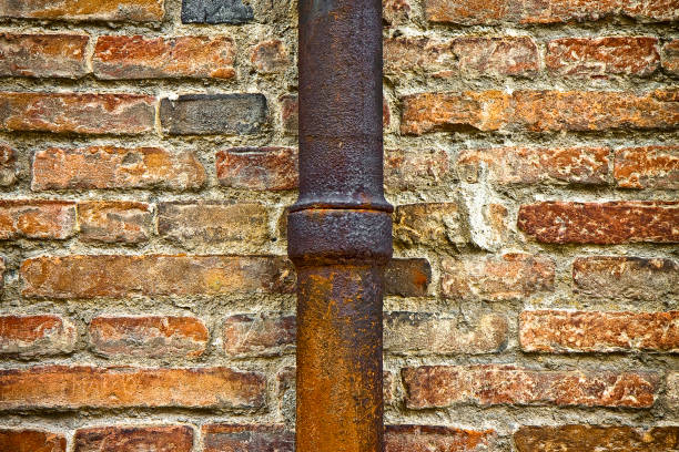 A close-up view of weathered metal blocks showcasing rust and corrosion. The strong colors and textures highlight industrial decay and urban aesthetics.