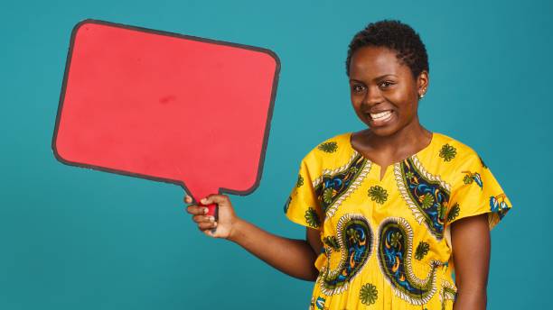 istock Smiling person showing a red isolated speech bubble in studio 2158112782